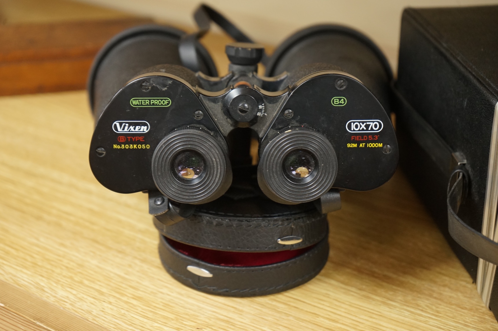 A cased pair of Vixen B Type 10x70 binoculars, stamped ‘Waterproof’, B4 Field 5.3 ‘92M at 1000M’, serial no. 303K050, with rubber shade guards, lens caps and integral tripod mounting, binoculars 27cm long, with the origi